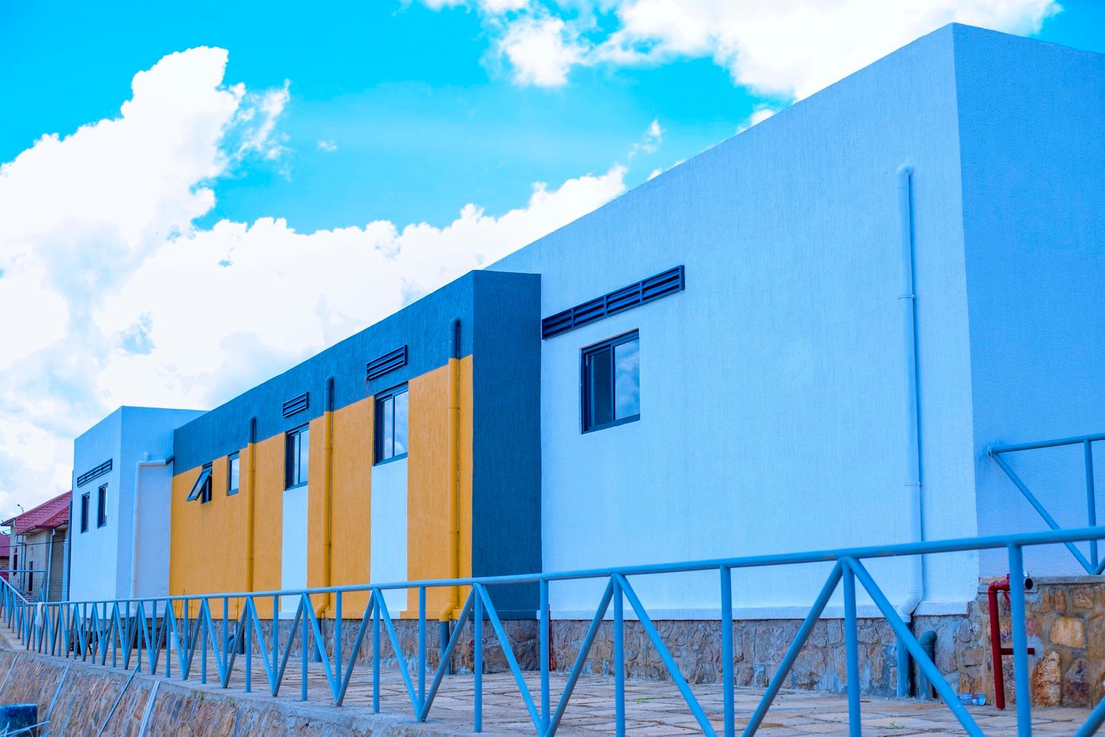 Newly built classroom blocks in white, grey, and yellow